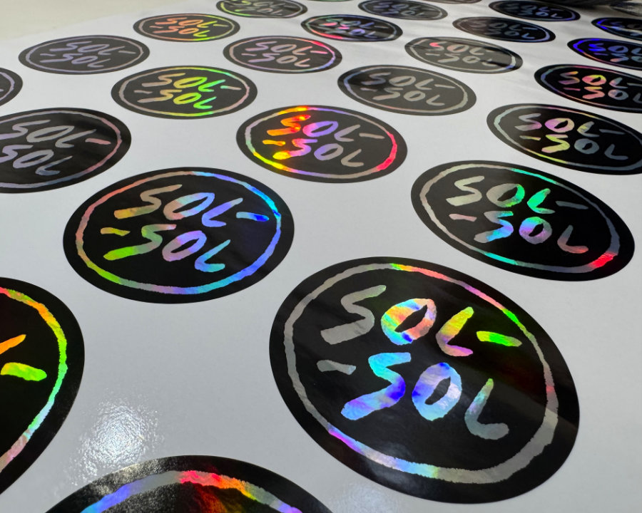 Holographic Sol-Sol circular stickers on a sheet