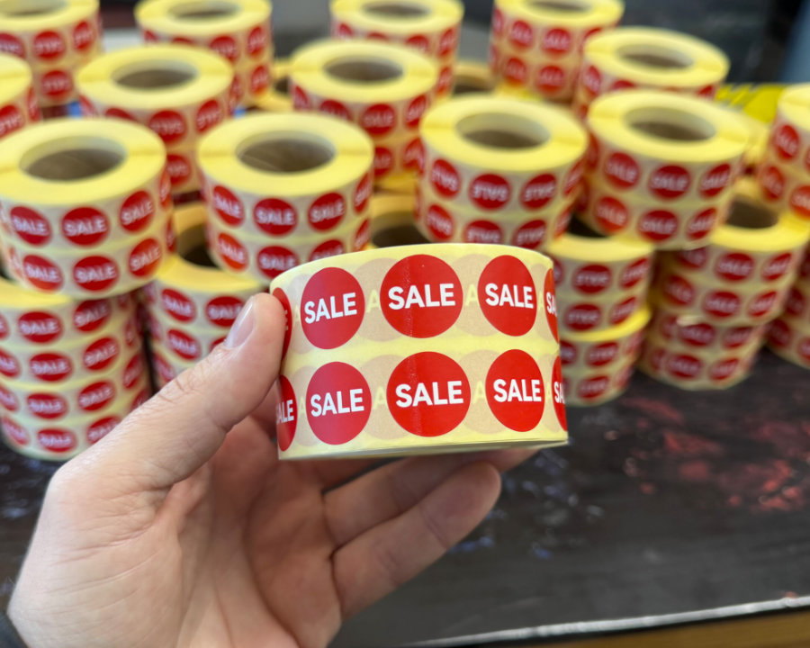 Stacks of red and white circular Sale price labels